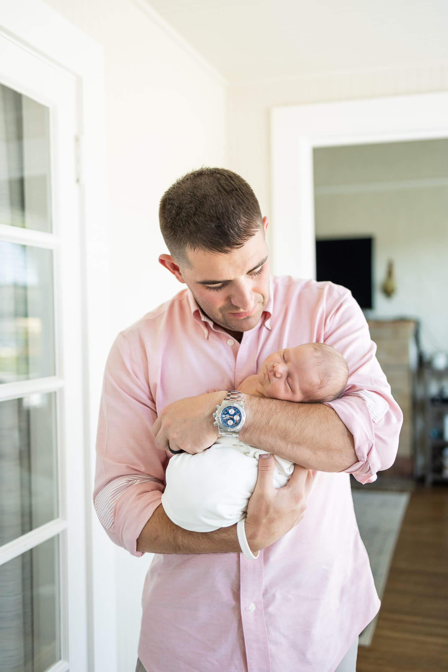 father holding his newborn baby girl